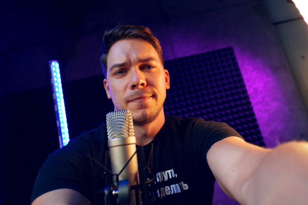 Young man in recording studio using microphone